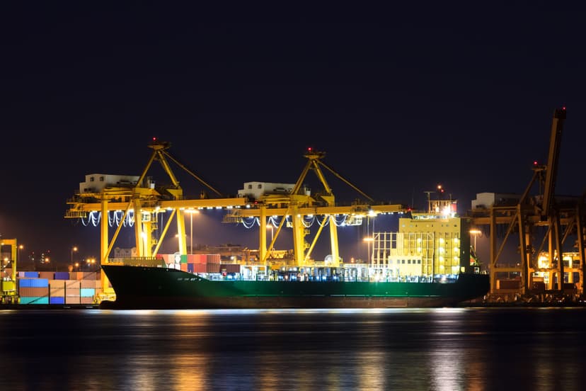 Port cranes and containers during sunset